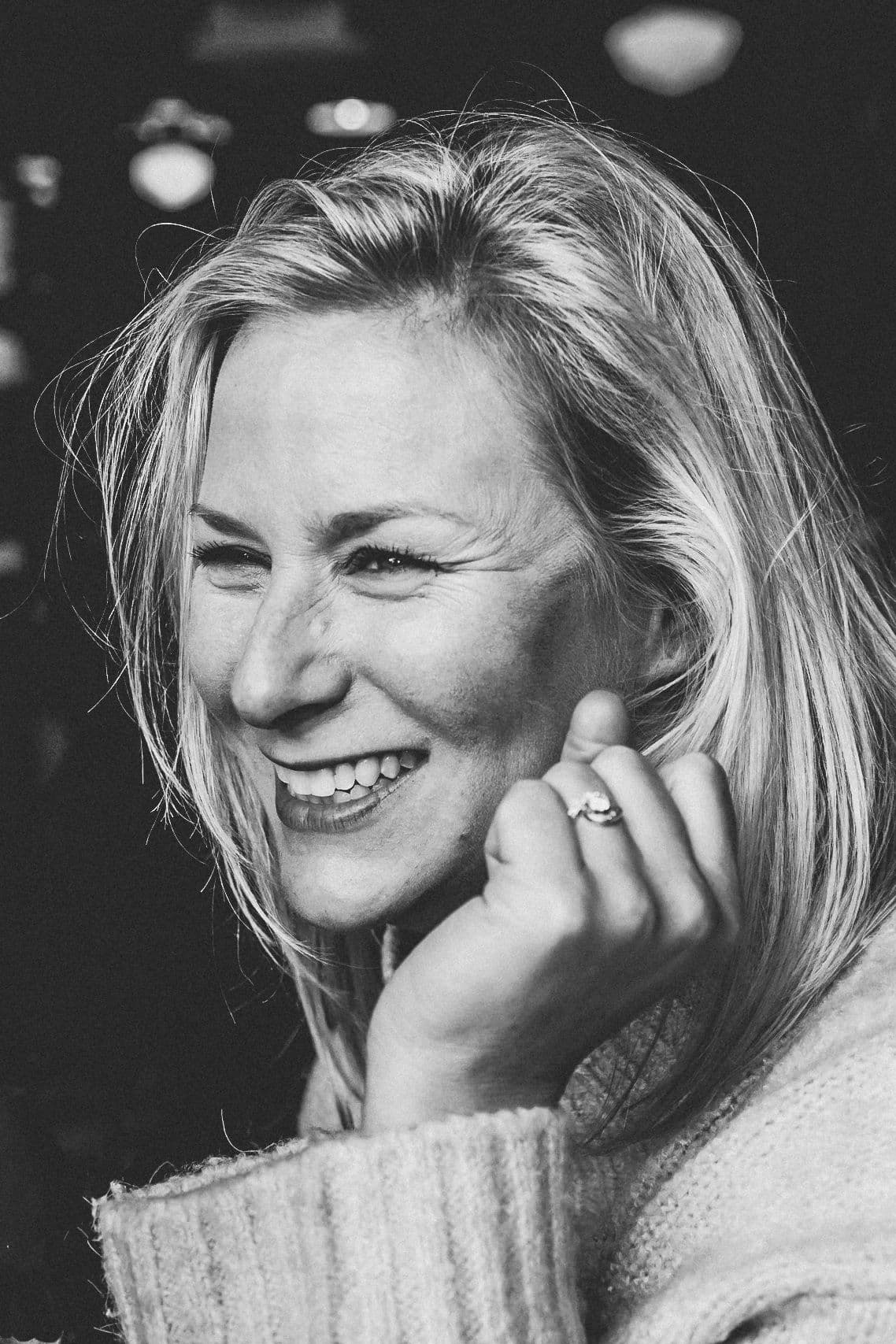 Photographer Sharon Amy laughing, in black and white